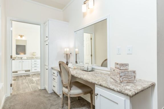 The 1714 Heritage not only has a stunning primary bedroom and bathroom but also an amazing built-in vanity with a large mirror, marble-style counter and plenty of cabinets and drawers for storage.