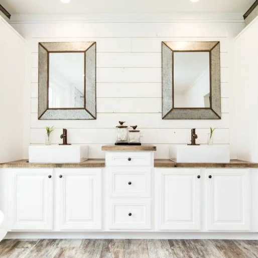 The bathroom in [model name] features double vanity sinks and ample storage space.