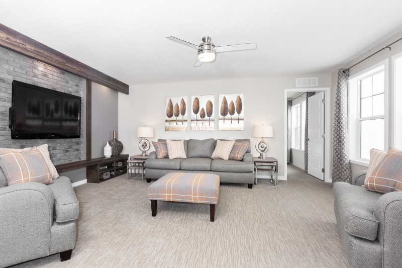 Shaw carpet in a manufactured home living room with gray furniture.
