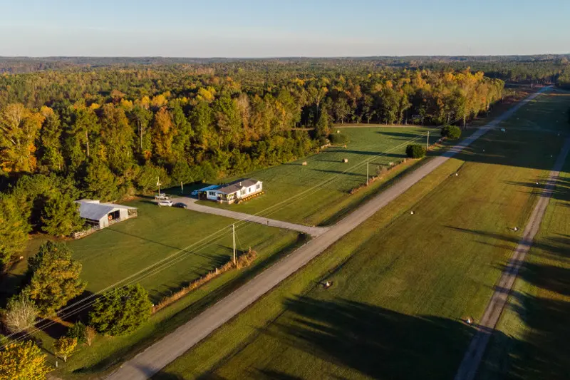 Aerial view of manufactured home property next to a runway. 