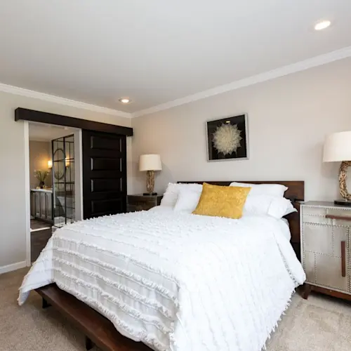 The bedroom in The Freedom Soho features a sliding door to the bathroom and a walk-in closet.