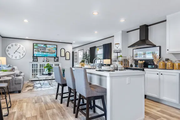 The Colossal features a kitchen island with built-in sink and a spacious living room.