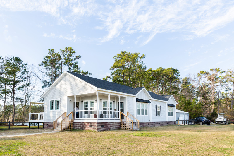 Farmhouse offsite built home with porch and garage 