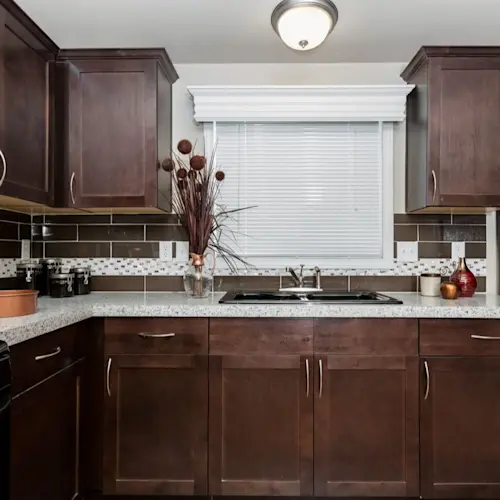 The angled kitchen of K2744A has tons of cabinet space, a snack bar, backsplash and pantry.