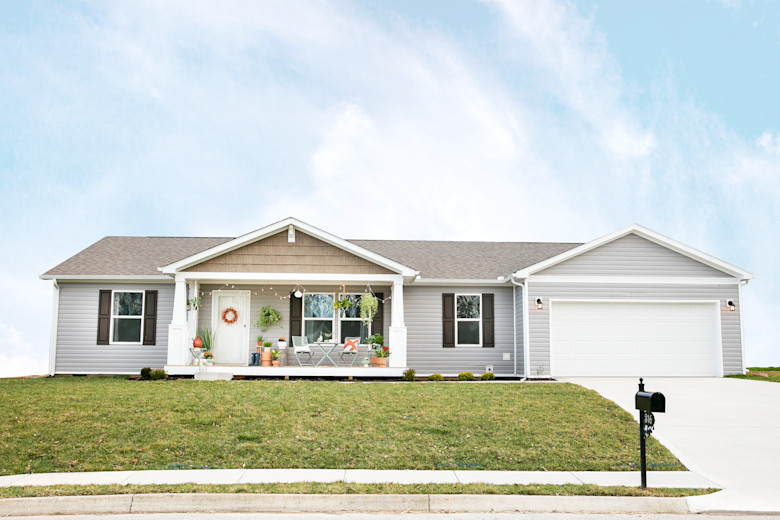 Manufactured home with a large front yard and garage.