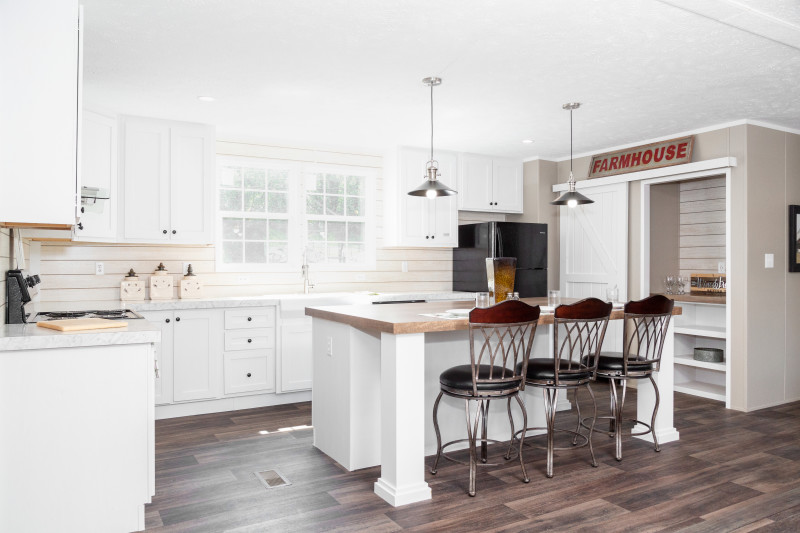 Kitchen of the Island Breeze 64 model, with kitchen island, breakfast bar and shiplap detailing.