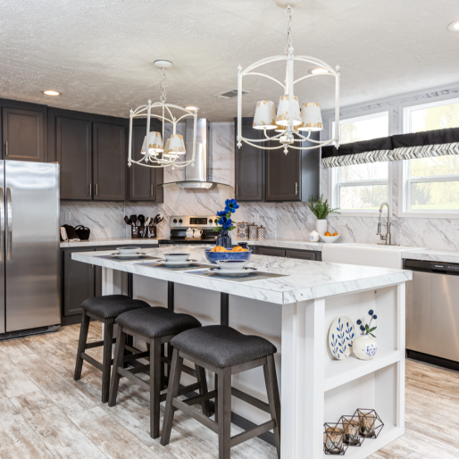 The [model name] kitchen boasts modern built-in storage, plenty of seating for the family and stainless steel appliances.