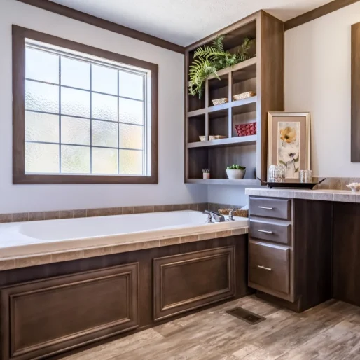 This primary bathroom is massive and features a tub with storage next to a built-in vanity, along with a huge shower with a bench and glass wall.