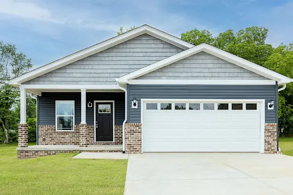 The [model name] features a garage and brick-style skirting.