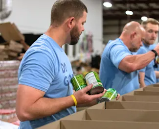 Clayton team member packages food drive boxes after hurricane Helene.