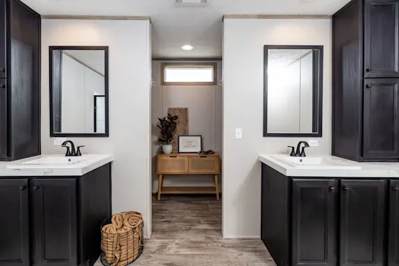 The [model name] features a primary bathroom with two separate sinks and a walk-in closet.