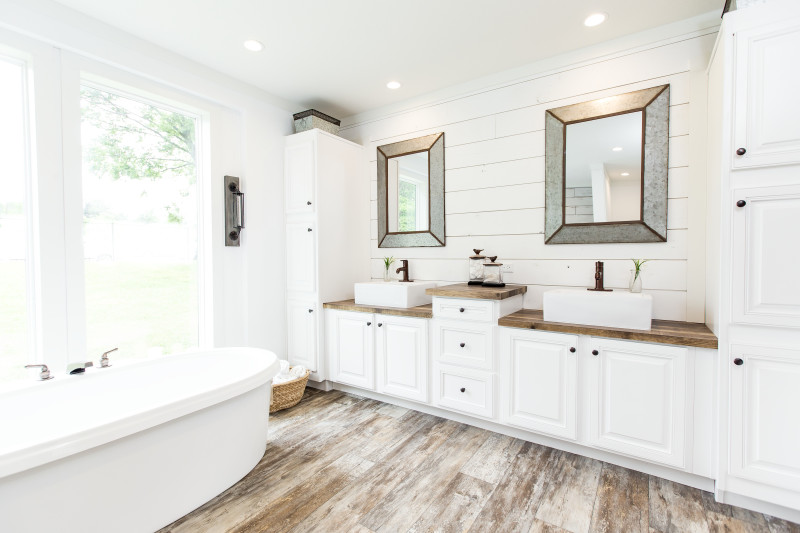 Manufactured home master bathroom with white shiplap and double sinks.