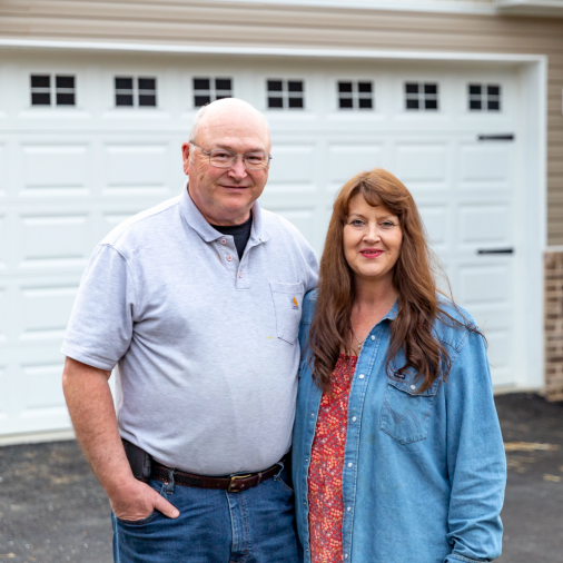Richard and Judy Parker stand outside their retirement home exterior built by Clayton manufactured homes.