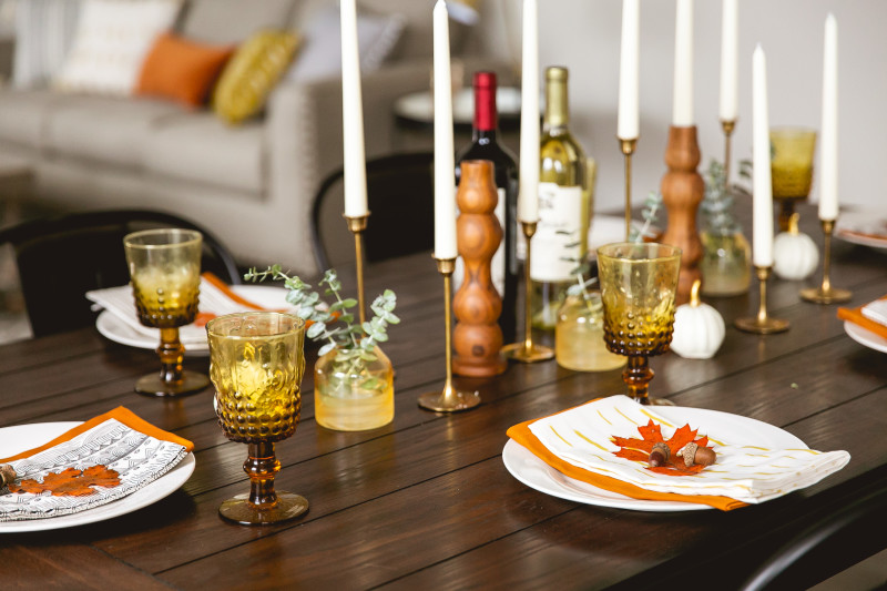Dining room table of a manufactured home decorated with many candle holders.