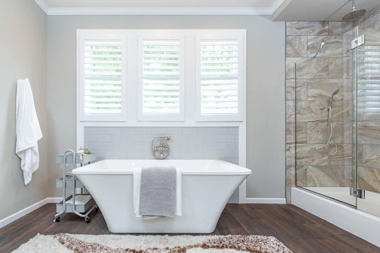 Manufactured home primary bathroom with a large soaker tub and walk-in shower.