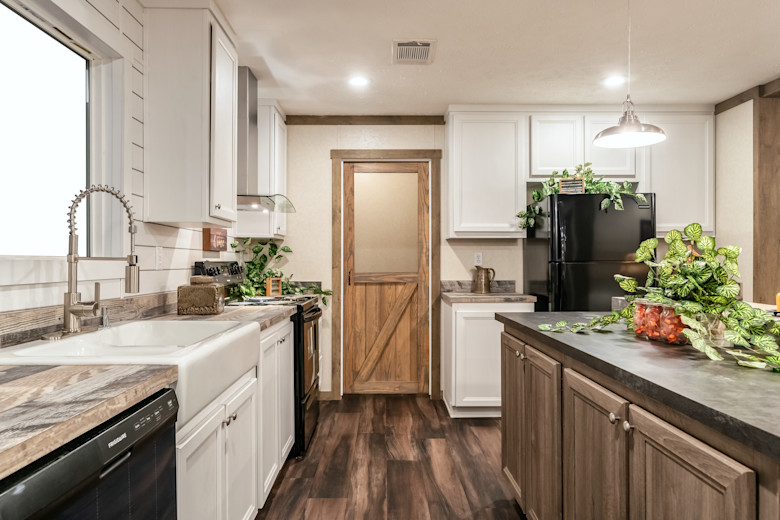 Modular home living room with refinished wooden doors and wooden flooring.