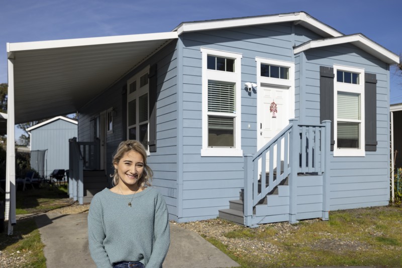 Maria Cibrian standing in front of her manufactured home