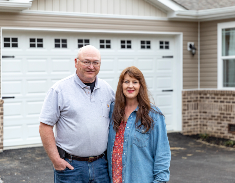 Richard and Judy Parker stand outside of their Clayton home in New Tazewell, TN.
