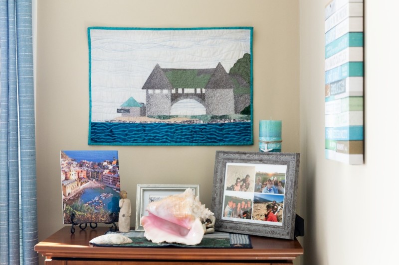 Family photos and sentimental items displayed on dresser and wall