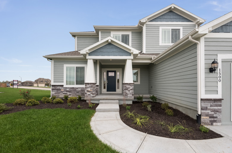 Exterior of two-story home with featured stone siding.