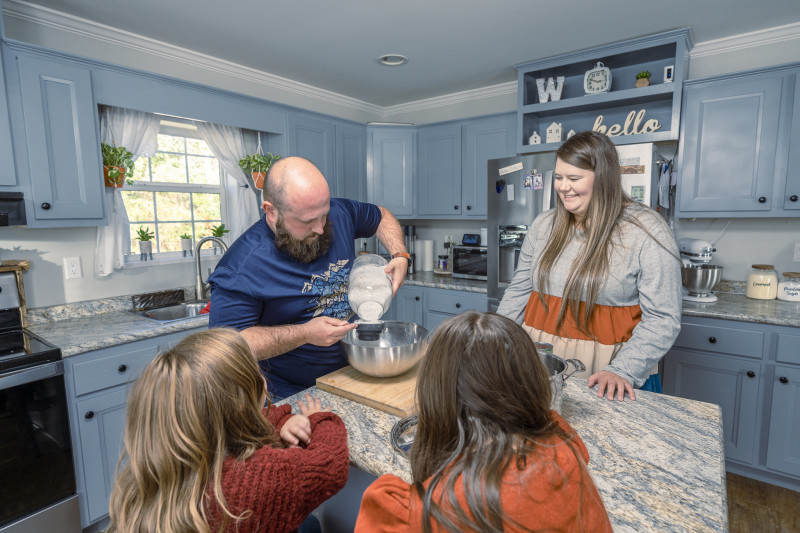 The Woody family baking together in their kitchen