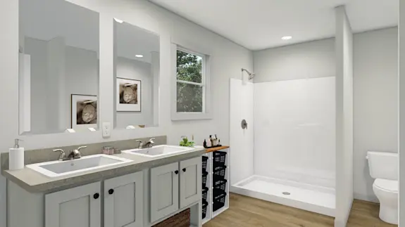 The [model name] bathroom features a walk-in shower and dual sinks.