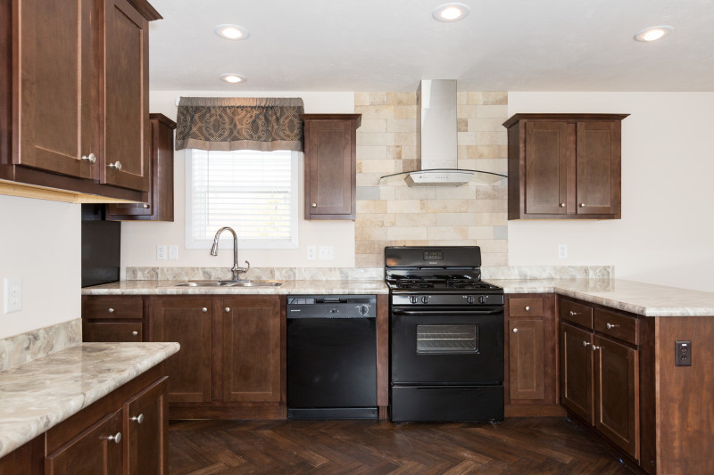 Kitchen featuring stove and counters and cabinets.