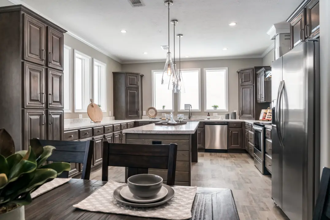 View of dining and kitchen with bright windows and island