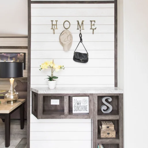 A beautiful shiplap accent wall sets the tone for the home and this entryway found in our [model name] is sure to dazzle friends and family alike.