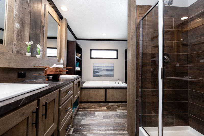 Primary bath in a manufactured home with double sink, walk in shower and soaking tub.