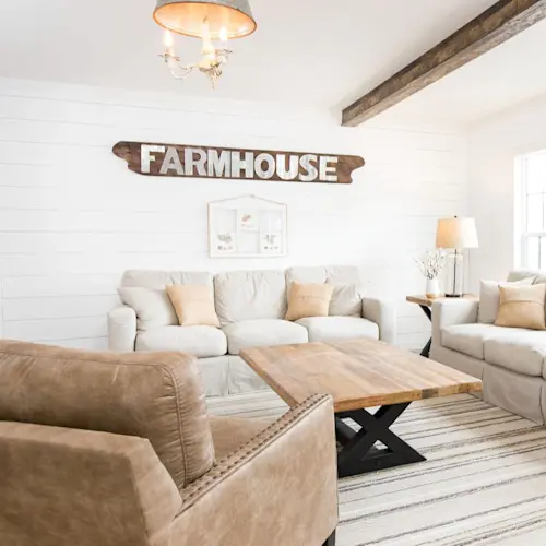 Large windows, shiplap feature wall and exposed wood style beams make The Lulabelle living room a comfortable place to relax.