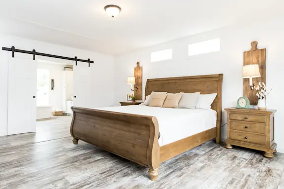 The [model name] features rustic details and an open, airy primary suite.