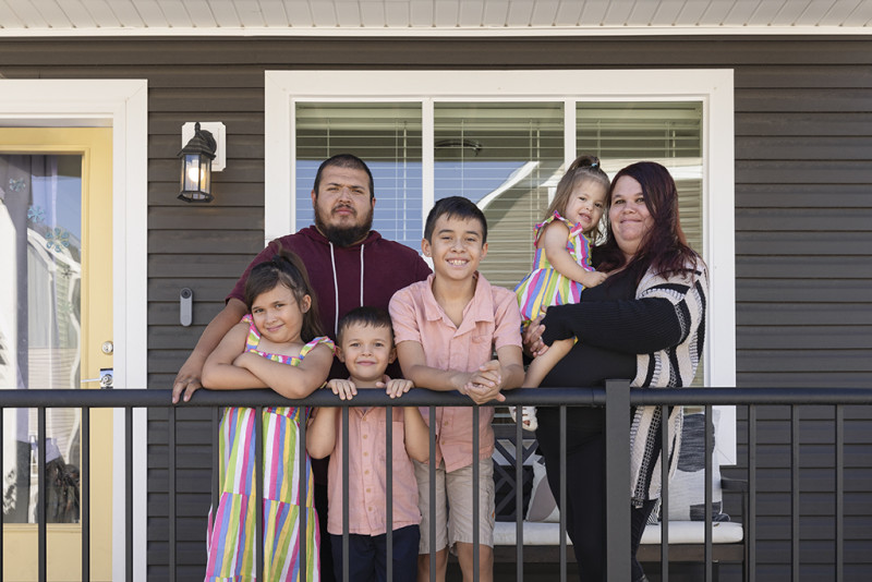 The Cebreros family standing on their porch