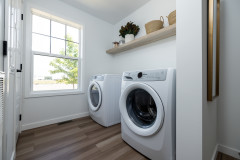 Laundry room with shelf and window