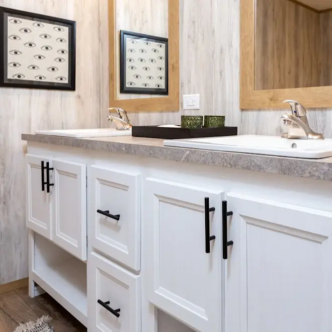 The bathroom in Sydney features granite-style counters and birch-style wallpaper.
