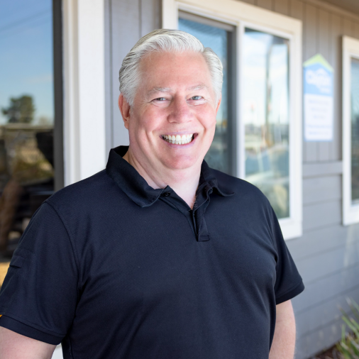 Dustin Youngdahl, a home center manager stands outside of his new Clayton manufactured home.