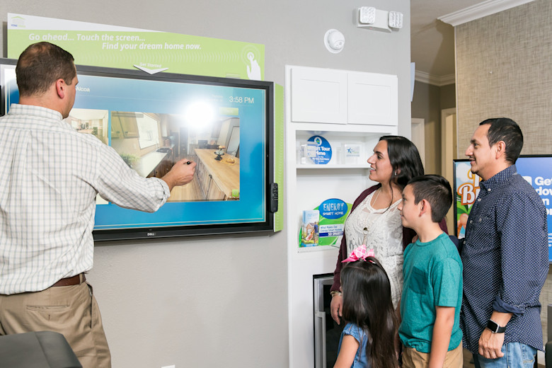 Home consultant showing family features of home at home center.