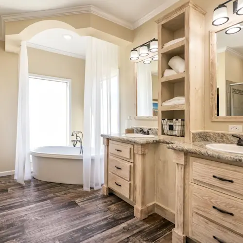 The bathroom of Chambord has a stunning French style to it, with plentiful light and storage along with a standalone soaker tub.