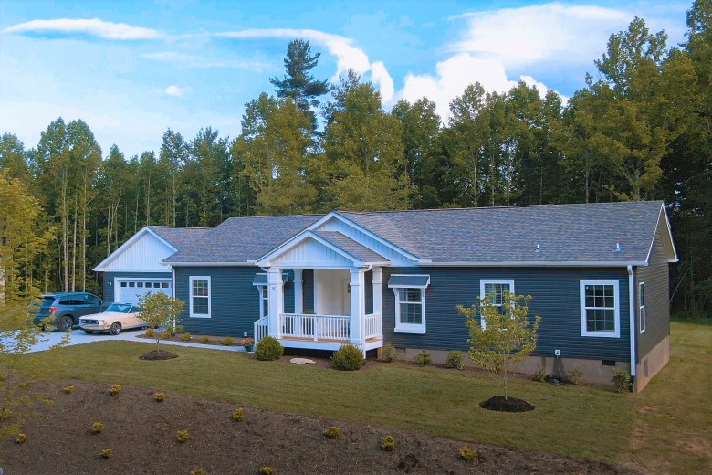 Exterior view of Clayton CrossMod home with two cars parked in front of garage