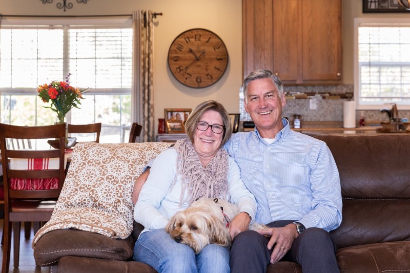 Rob and Katie Allyn sitting on the couch with their dog