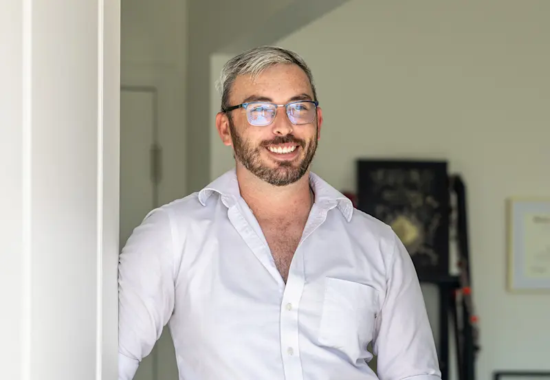  Justin Jones standing at the front door of his Oakwood Home