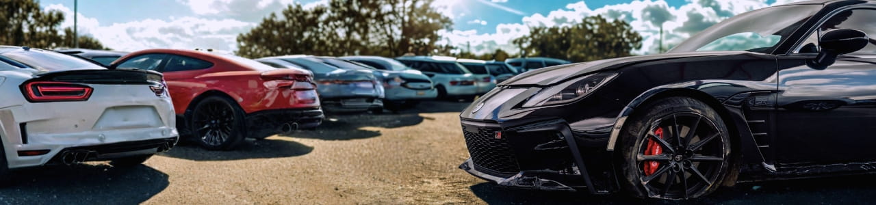Cars parked in IAA lot under a sunny sky