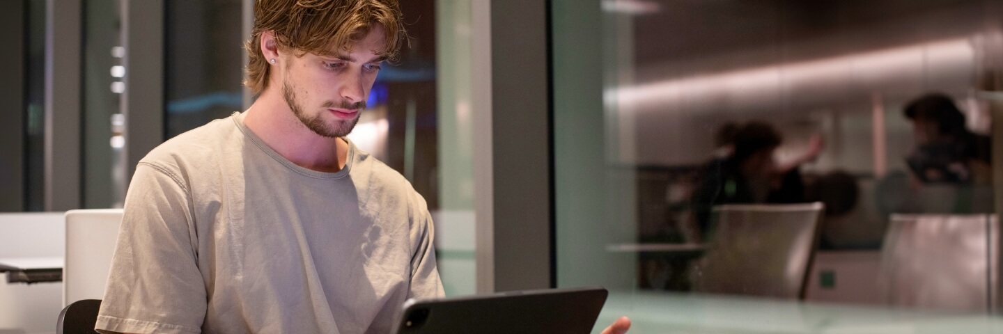 Lynn student working on a laptop in a school building