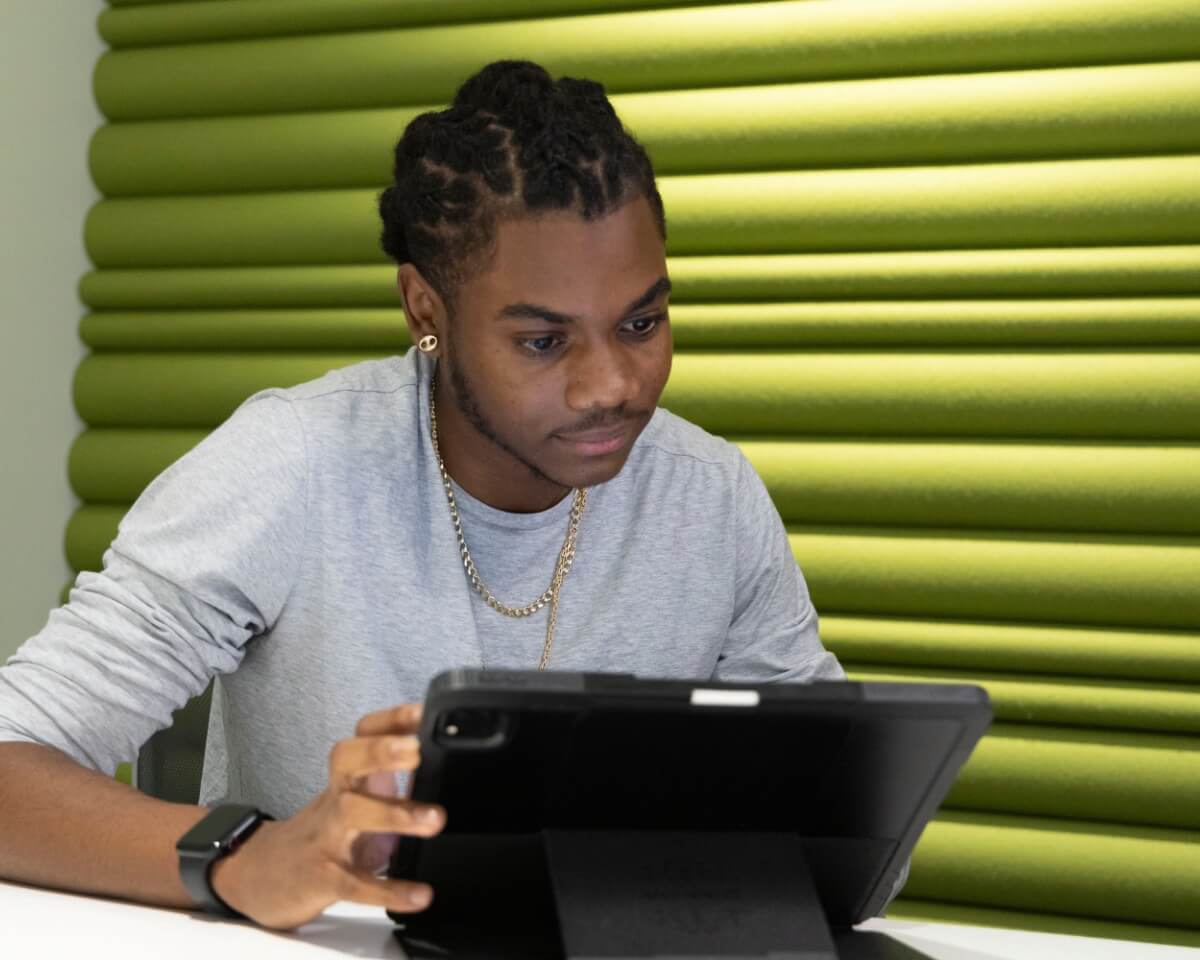 Lynn student concentrating and working on tablet/laptop