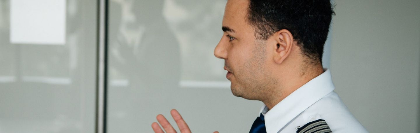 Pilot speaking in a hallway