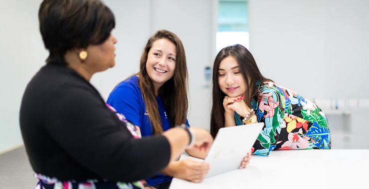 Students reviewing a class assignment.