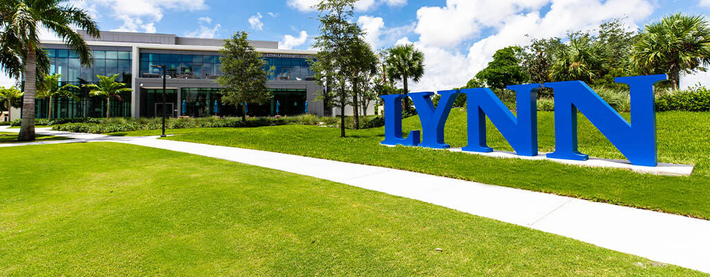 Exterior of Lynn University with large Lynn sign in the foreground