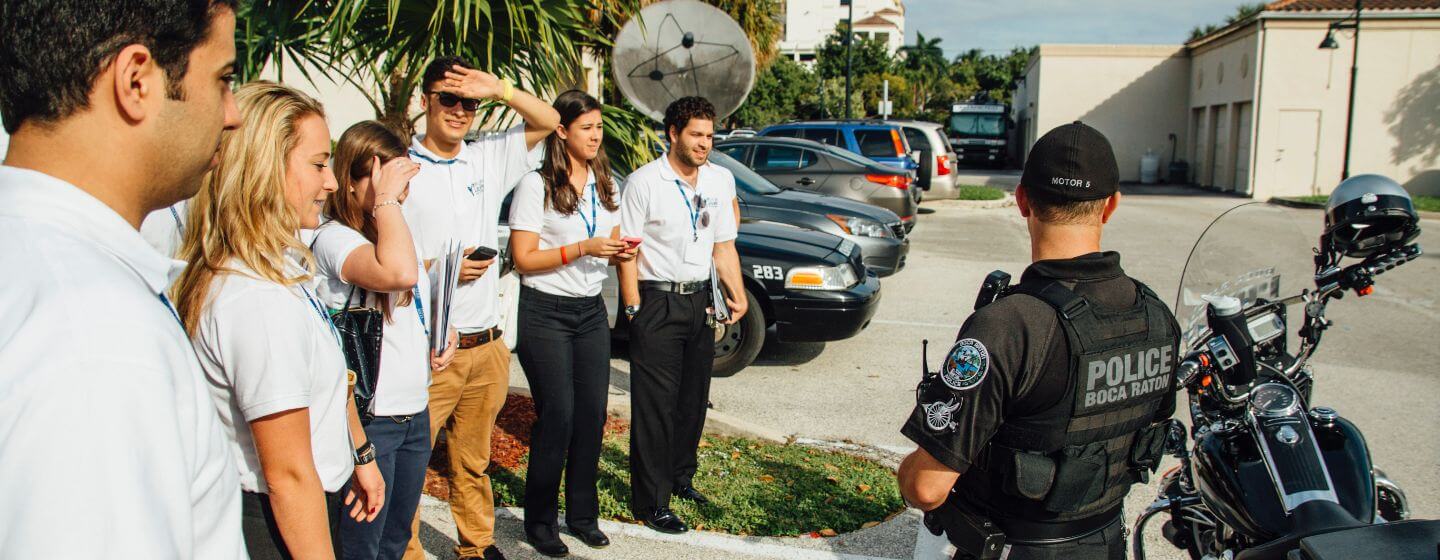 Group of Lynn criminal justice students speaking with a uniformed officer