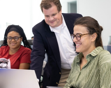 group of Lynn students looking at a laptop