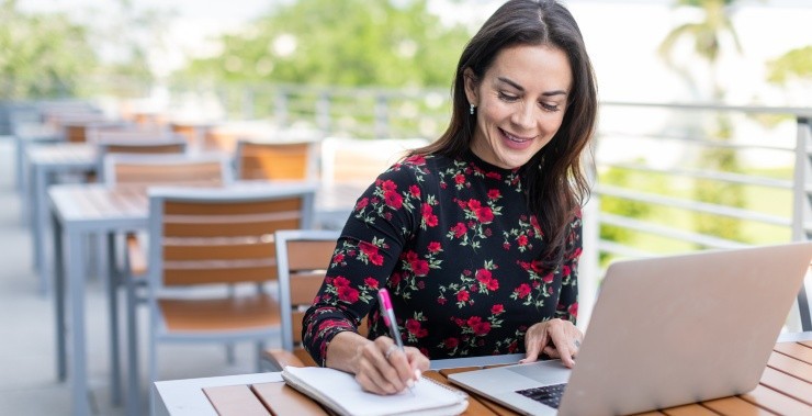 Woman looking up marketing resources online as she studies.